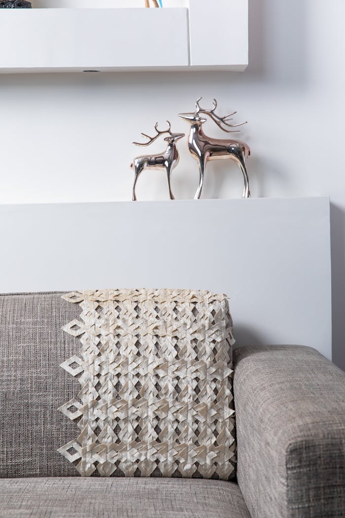 pexels-photo-3614086 Modern living room with metallic deer decor and cozy sofa.